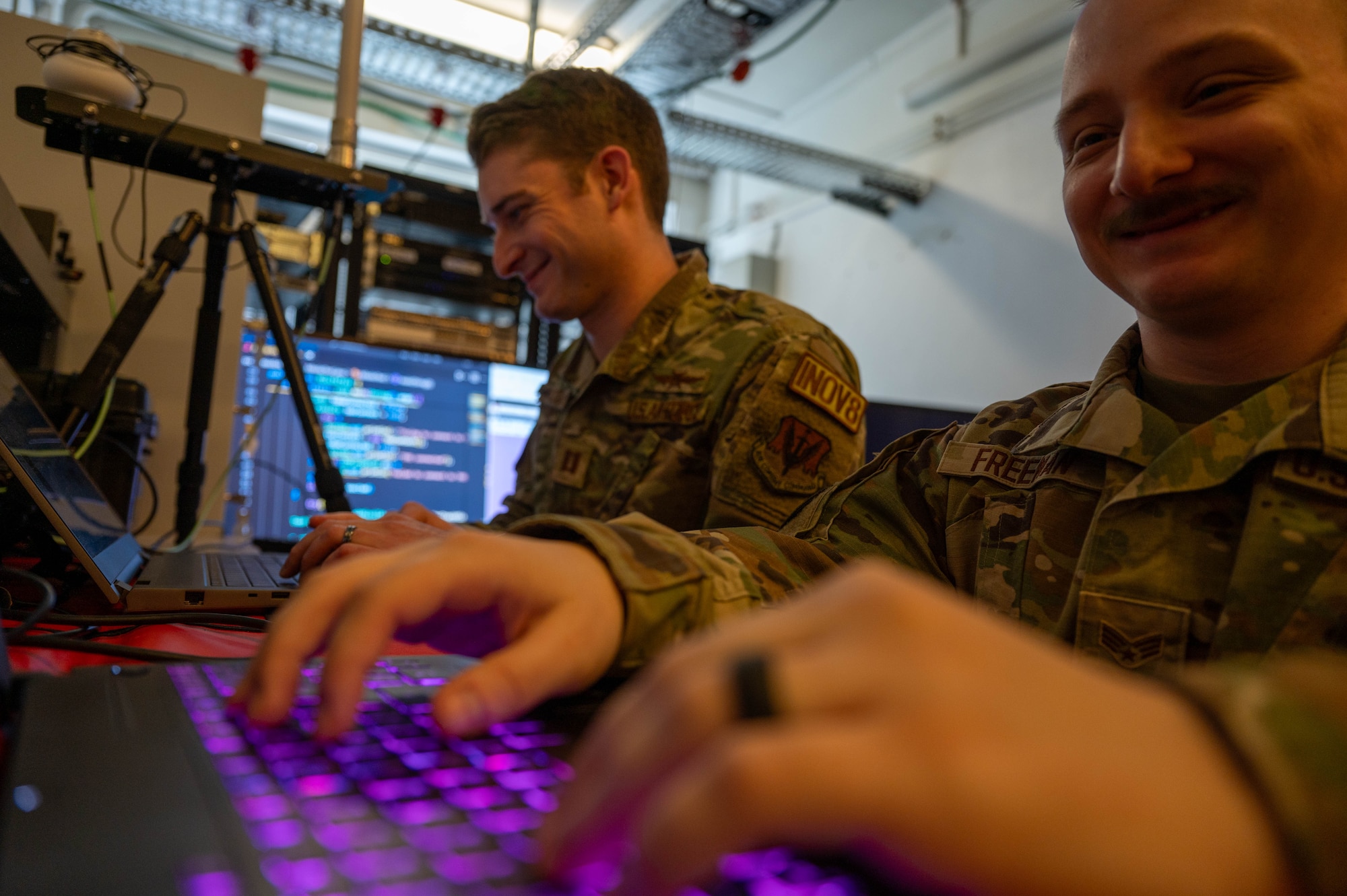 U.S. Air Force Capt. Isaiah Nicolai, Project Arc software developer, and Senior Airman Brandon Freeman, Project Arc computer scientist, work on coding to aid in Global Command and Control System processing improvements at Kapaun Air Station, Germany, April 9, 2024. The newly-implemented system developed by the Project Arc team will combine the GCCS with additional software to provide a blueprint for ground forces in combative preparation, planning and positioning—enabling them to move faster and smarter against adversaries. (U.S. Air Force photo by Senior Airman Jordan Lazaro)