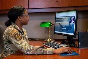 Photo of Airman looking at a computer screen.