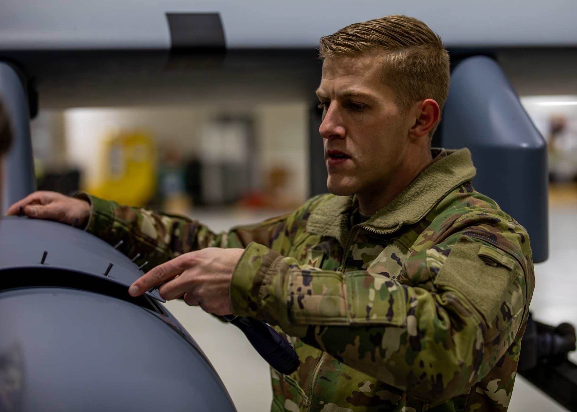 Tech Sgt. Robert Van Wyhe from the 163rd Attack Wing inspects a remotely piloted MQ-9 Reaper from the 163rd Attack Wing at the 178th Wing on Springfield-Beckley Air National Guard Base, Ohio, March 12, 2024. Exercise Advanced Wrath gives the 178th Wing an opportunity to support an MQ-9 Reaper locally with airmen from across the country. (U.S. Army National Guard photo by Staff Sgt. Thomas Moeger)