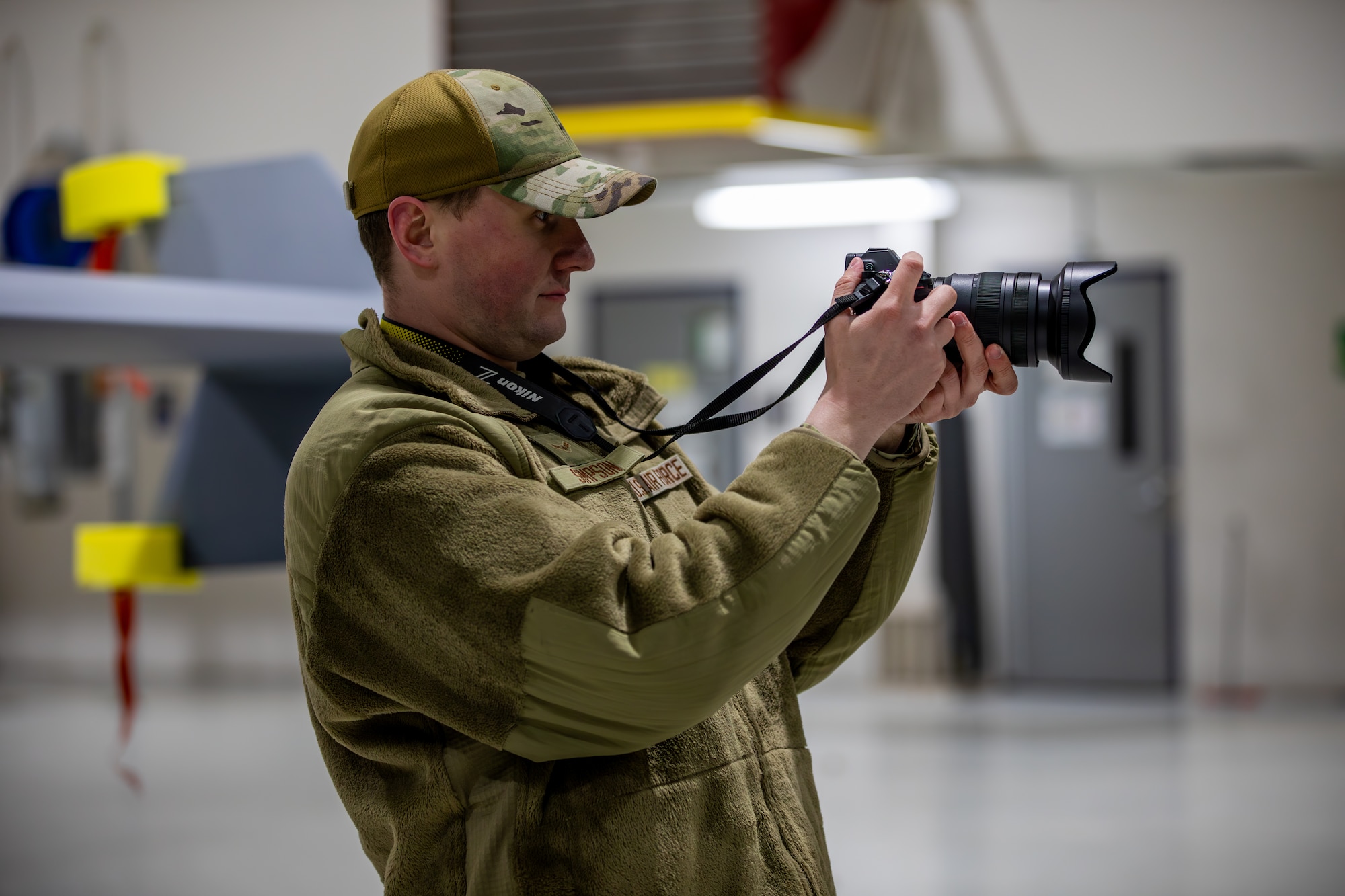 Airman 1st Class Colin Simpson, a public affairs specialist assigned to the 178th Communications Flight, takes a photograph following the landing of a remotely piloted MQ-9 Reaper from the 163rd Attack Wing at the 178th Wing on Springfield-Beckley Air National Guard Base, Ohio, March 12, 2024. Exercise Advanced Wrath gives the 178th Wing an opportunity to support an MQ-9 Reaper locally with airmen from across the country. (U.S. Army National Guard photo by Staff Sgt. Thomas Moeger)