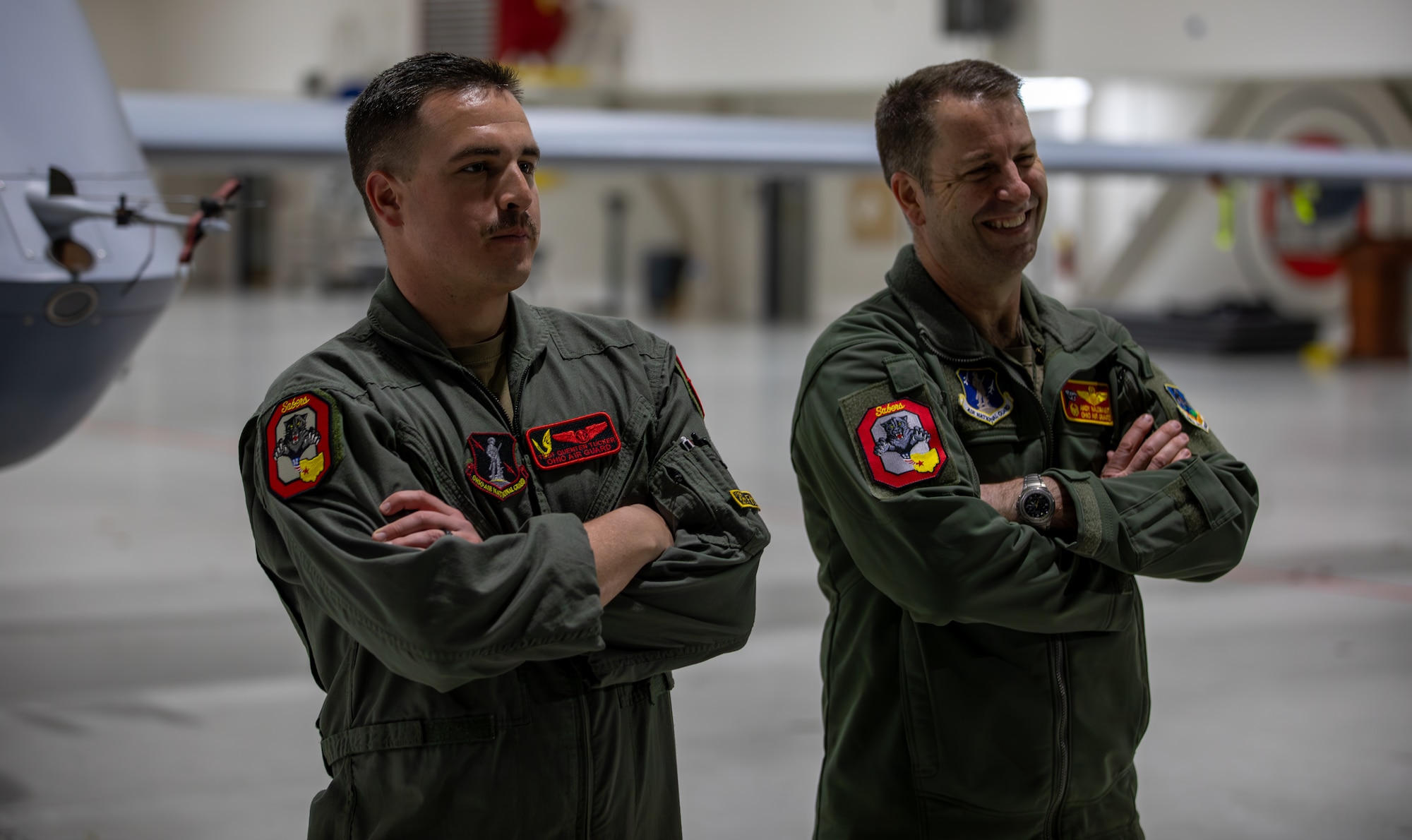 Col. Andy Kazmaier, right, 178th Wing commander, and Tech. Sgt. Quenten Tucker, left, an MQ-9 sensor operator assigned to the 178th Wing, stand for a photograph following the landing of a MQ-9 Reaper on Springfield-Beckley Air National Guard Base, Ohio, March 12, 2024. The historic landing marks the beginning of exercise Advanced Wrath, demonstrating the operational capabilities of the Ohio National Guard to the greater U.S. Air Force. (U.S. Army National Guard photo by Staff Sgt. Thomas Moeger)