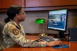 Photo of Airman looking at a computer screen.