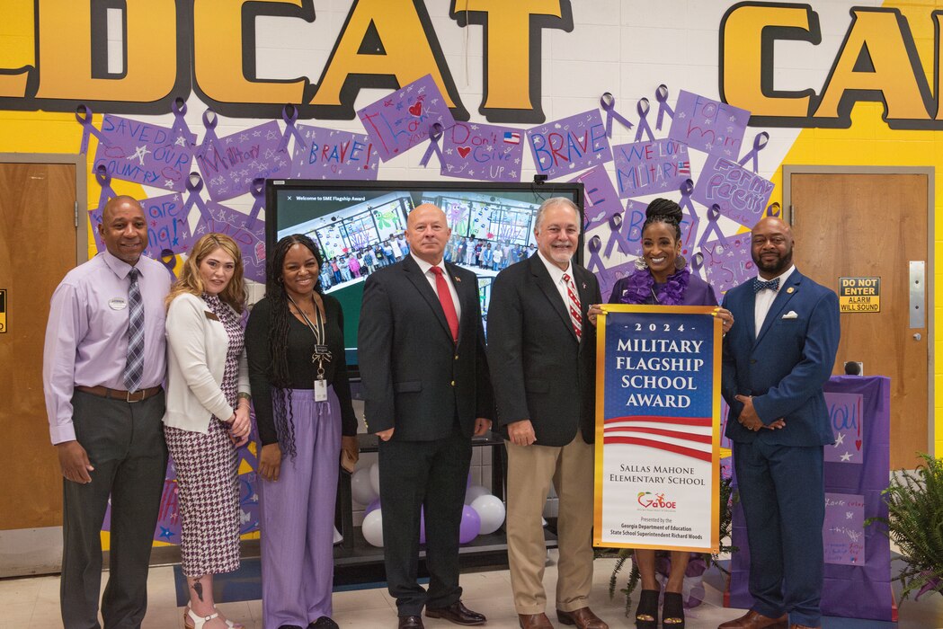 Moody Air Force Base and the Georgia Department of Education representatives   pose for a picture presenting a Flagship School Award