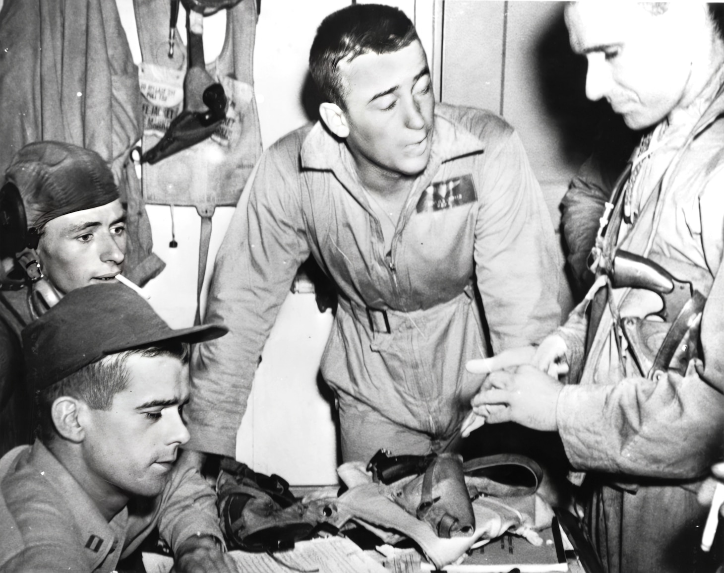 Battle of Leyte Gulf, October 1944. Bombing squadron 13 commanding officer Lieutenant Charles Skinner (center) describing his unit's attack on the Japanese fleet in Sibuyan Sea, 24 October 1944. Taken aboard USS FRANKLIN (CV-13).
