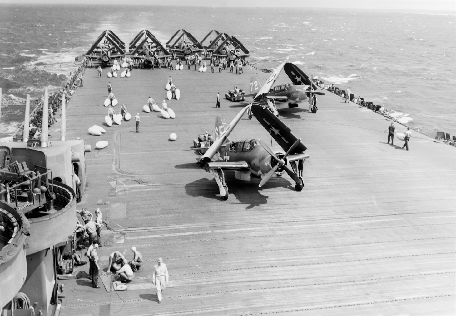 Battle of Leyte Gulf, October 1944. Loading drop tanks on SB2Cs aboard USS LEXINGTON (CV-16) before a search mission, on 25 October 1944