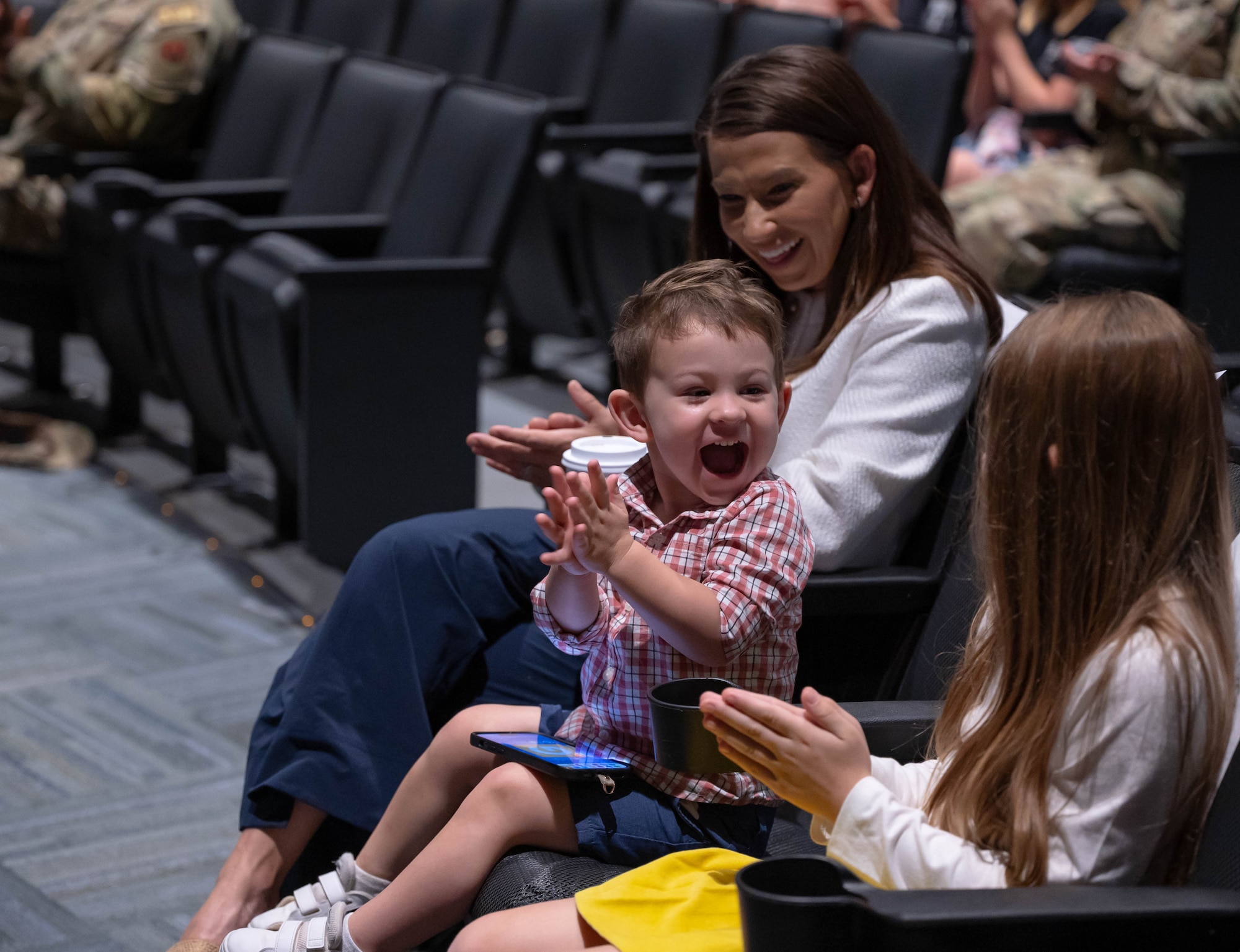 Wife of Retired U.S. Air Force Capt. Nathan Nelson, Jennifer, 10-year-old daughter, Eva, and 2-year-old son, Silas, encourages Nelson before his presentation to Airmen and Guardians of Space Launch Delta 45 during the National Prayer Day luncheon March 15, 2024, at Patrick Space Force Base, Florida. (U.S. Space Force photo by Joshua Conti)