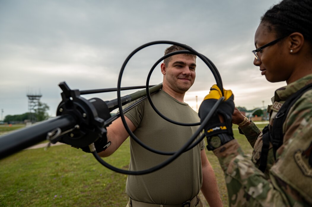 U.S. Air Force Airman 1st Class Samera Epperson, 23rd Communications Squadron tactical radio technician (right), and an Airman assigned to the 23rd CS organize cables for an antenna setup during Exercise Ready Tiger 24-1 atSavannah Air National Guard Base, Georgia, April 9, 2024. During Ready Tiger 24-1, the 23rd Wing will be evaluated on the integration of Air Force Force Generation principles such as Agile Combat Employment, integrated combat turns, forward aerial refueling points, multi-capable Airmen, and combat search and rescue capabilities. (U.S. Air Force photo by Senior Airman Courtney Sebastianelli)