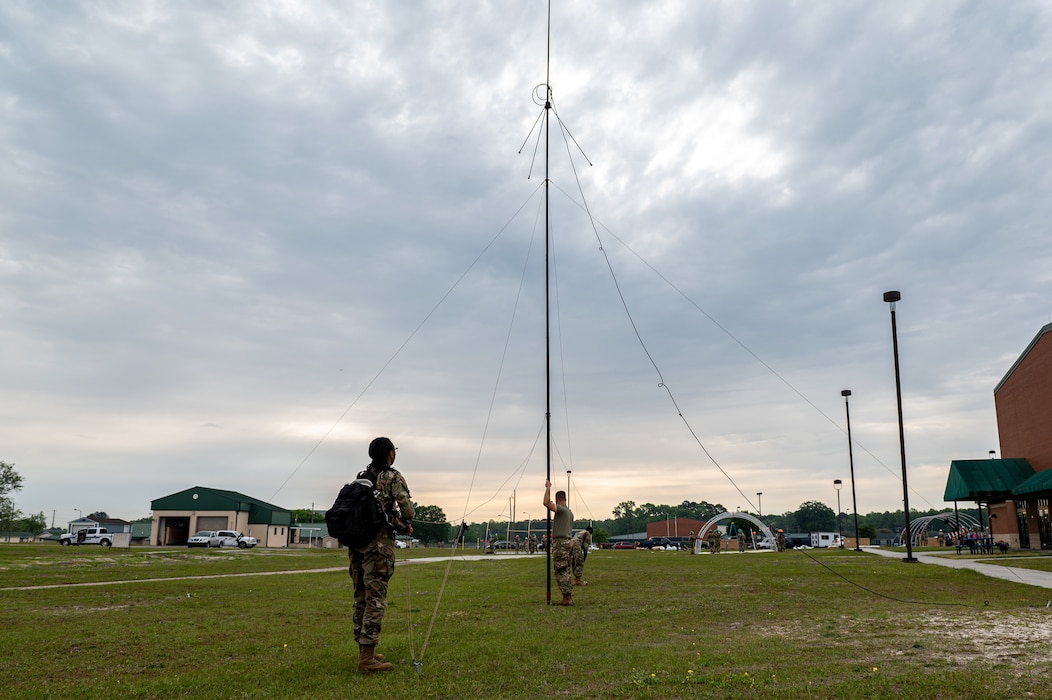 U.S. Airmen assigned to the 23rd Communications Squadron set up an antenna during Exercise Ready Tiger 24-1 at Savannah Air National Guard Base, Georgia, April 9, 2024. During Ready Tiger 24-1, exercise inspectors will assess the 23rd Wing's proficiency in employing decentralized command and control to fulfill air tasking orders across geographically dispersed areas amid communication challenges, integrating Agile Combat Employment principles such as integrated combat turns, forward aerial refueling points, multi-capable Airmen, and combat search and rescue capabilities. (U.S. Air Force photo by Senior Airman Courtney Sebastianelli)