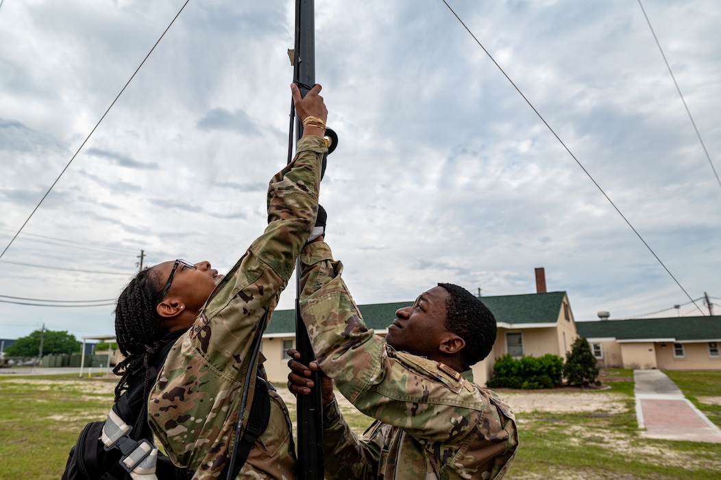 U.S. Air Force Airman 1st Class Samera Epperson, 23rd Communications Squadron tactical radio technician (left), and Senior Airman Gregory Owens, 23rd CS client system technician, set up an antenna during Exercise Ready Tiger 24-1 at Savannah Air National Guard Base, Georgia, April 9, 2024. Ready Tiger 24-1 is a readiness exercise demonstrating the 23rd Wing’s ability to plan, prepare and execute operations and maintenance to project air power in contested and dispersed locations, defending the United States’ interests and allies. (U.S. Air Force photo by Senior Airman Courtney Sebastianelli)