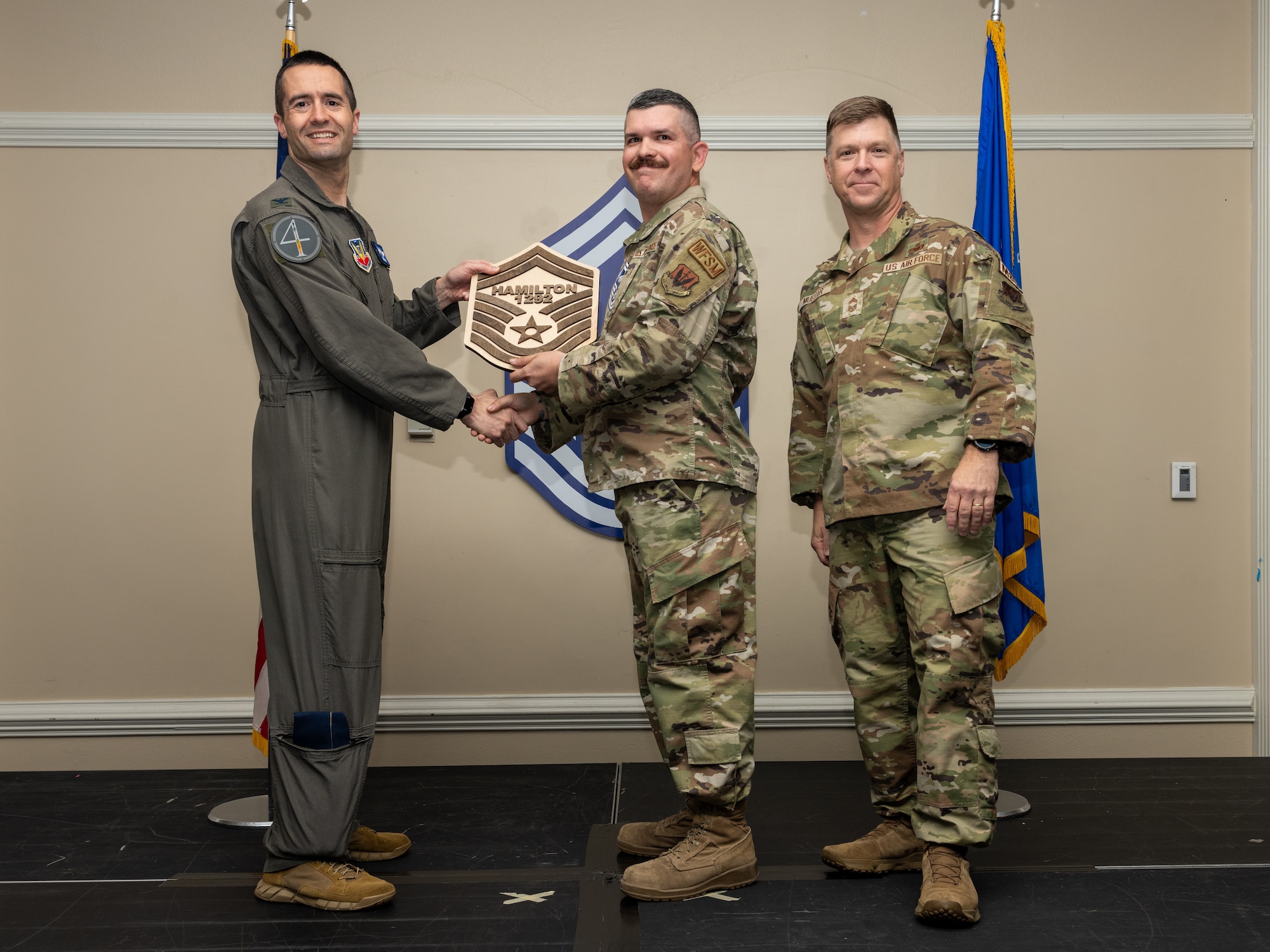 U.S Air Force Col. Morgan Lohse, 4th Fighter Wing commander (left), and Chief Master Sgt. Edward Mueller, Mission support Group senior enlisted leader, presents a plaque to Senior Master Sgt. select Mary Staats Walker (center), law office superintendent, during a Senior Master Sergeant release ceremony at Seymour Johnson Air Force Base, North Carolina, March 28, 2024. The ceremony allowed wing leadership, family and friends to recognize the base’s newest Senior Master Sergeant selects. (U.S. Air Force photo by Airman Megan Cusmano)