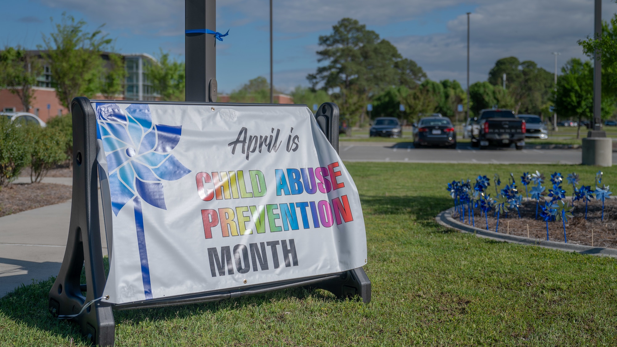 A sign is displayed on the 4th Medical Group lawn during a “Pinwheels for Child Abuse Prevention” event at Seymour Johnson Air Force Base, North Carolina, Apr. 4, 2024. The pinwheel symbolizes the innocence of children and the event was held to promote healthy and happy families. (U.S. Air Force Photo by Airman Rebecca Tierney)