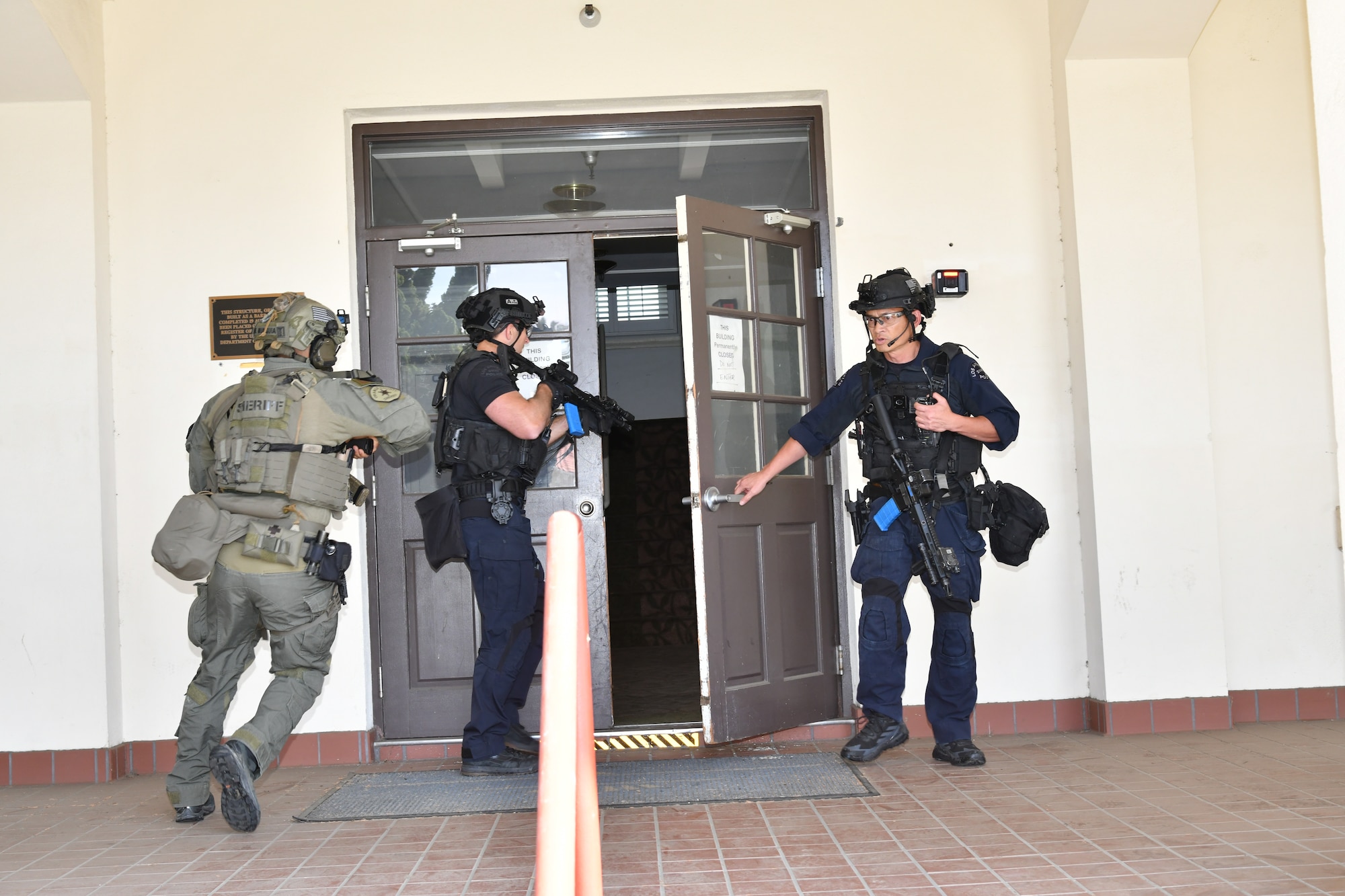 SWAT members pictured entering the front door of lodging on Fort Mac Arthur to begin their training.