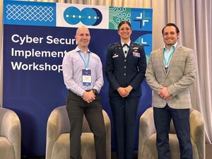 two men and one woman in a military uniform pose for a photo