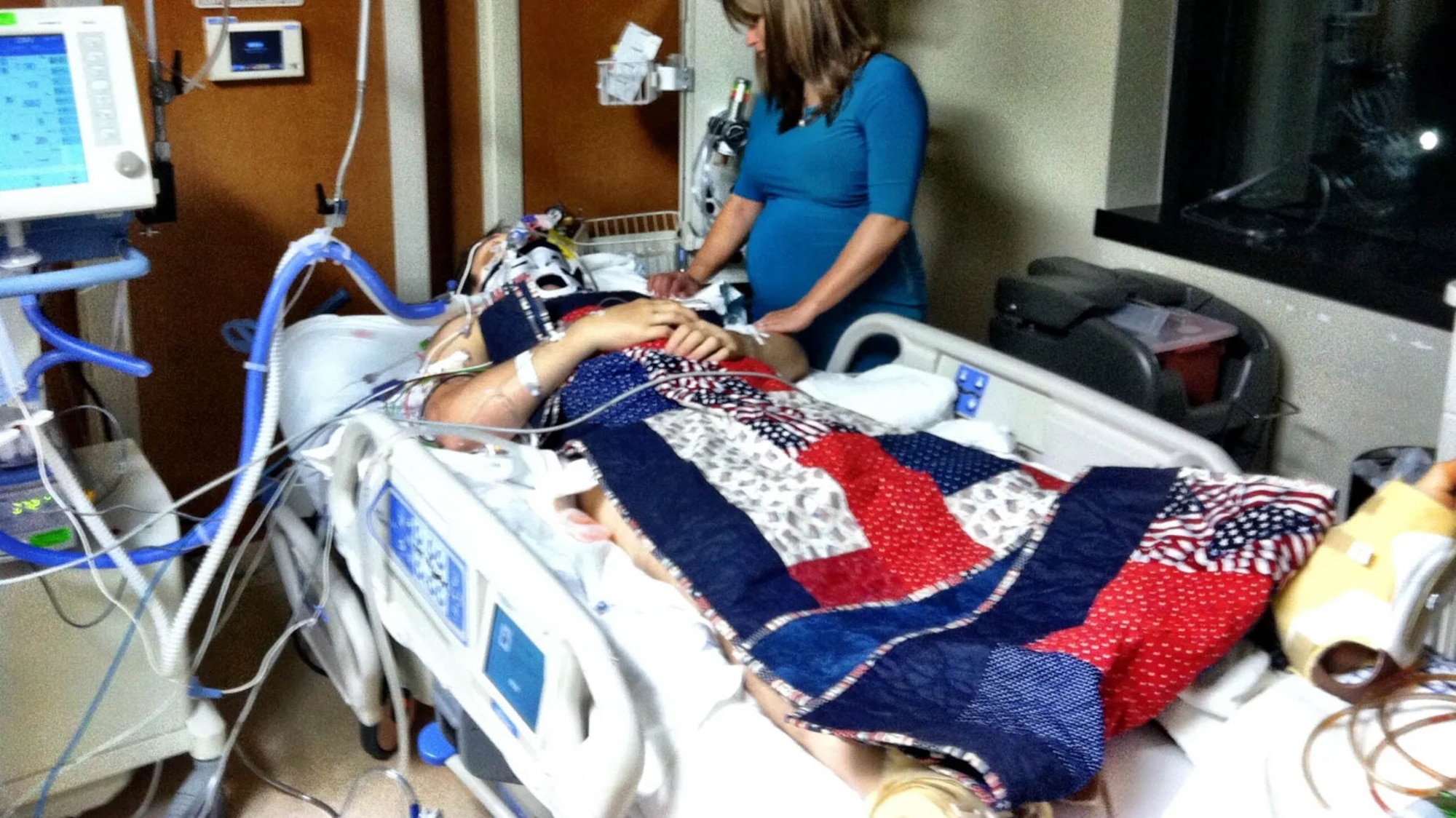 U.S. Air Force 1st Lt. Nate Nelson, 22nd Special Tactics Squadron intelligence officer, is comforted by his wife, Jennifer, at Walter Reed National Medical Center, Maryland. He was critically injured from a rocket attack in Afghanistan during Operation Enduring Freedom. (Courtesy photo)