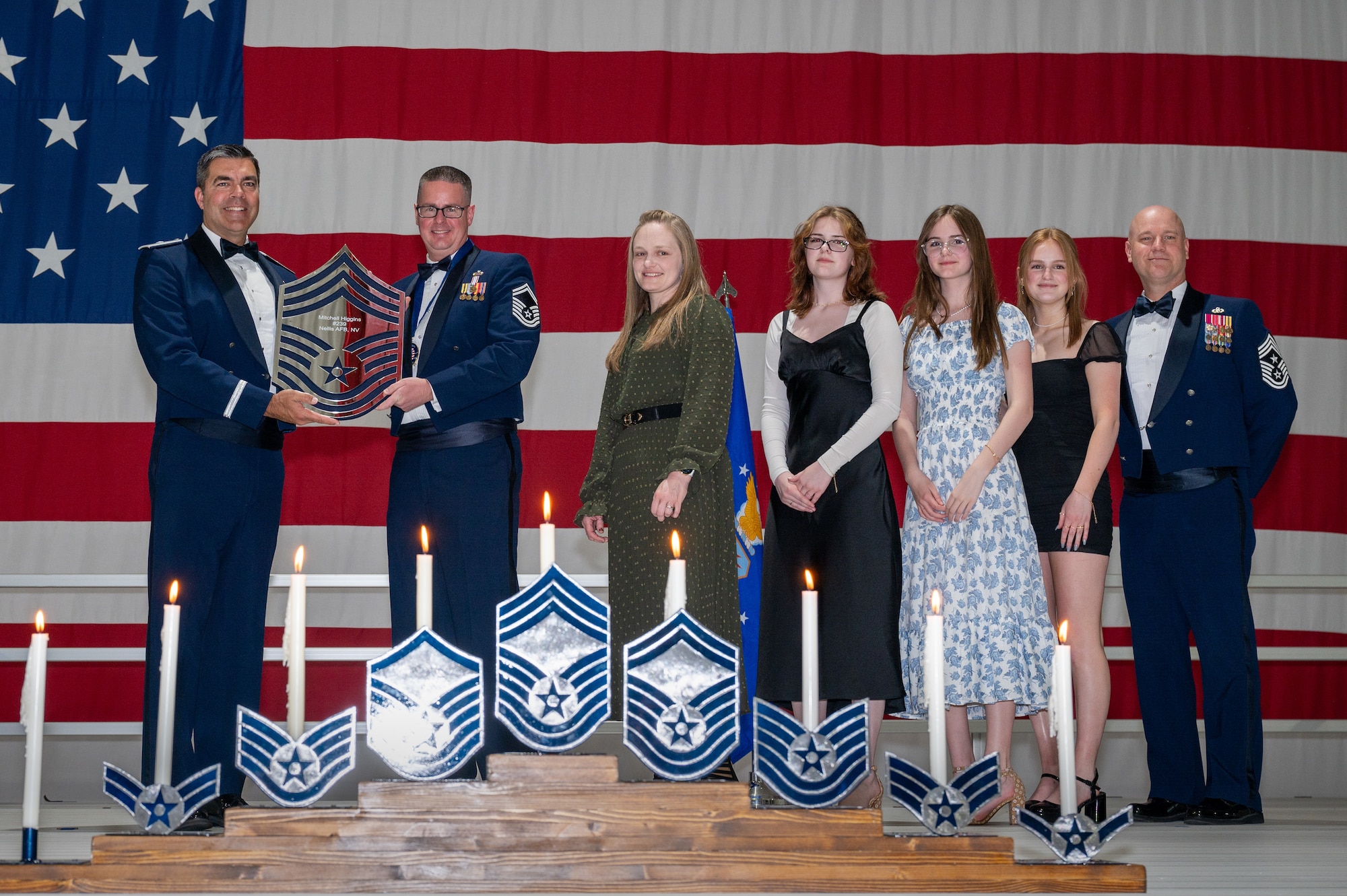 U.S. Air Force Senior Master Sgt. Mitchell Higgins, the 757th Aircraft Maintenance Squadron Raptor Aircraft Maintenance Unit superintendent, receives a recognition plaque during the chief master sergeant recognition ceremony at Nellis Air Force Base, Nevada, April 20, 2024.