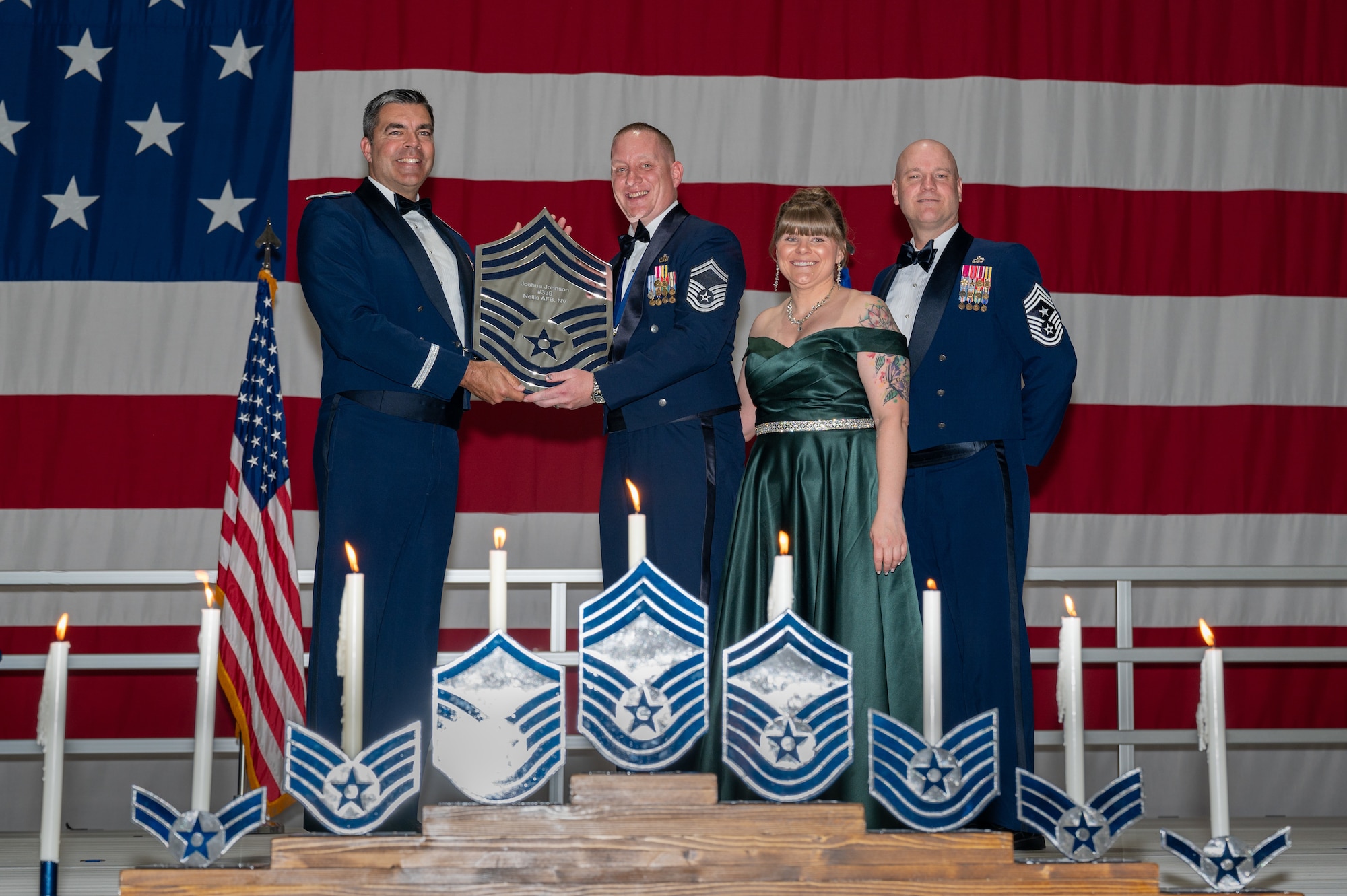 U.S. Air Force Senior Master Sgt. Joshua Johnson, the 757th Aircraft Maintenance Squadron Strike Aircraft Maintenance Unit superintendent, receives a recognition plaque during the chief master sergeant recognition ceremony at Nellis Air Force Base, Nevada, April 20, 2024.
