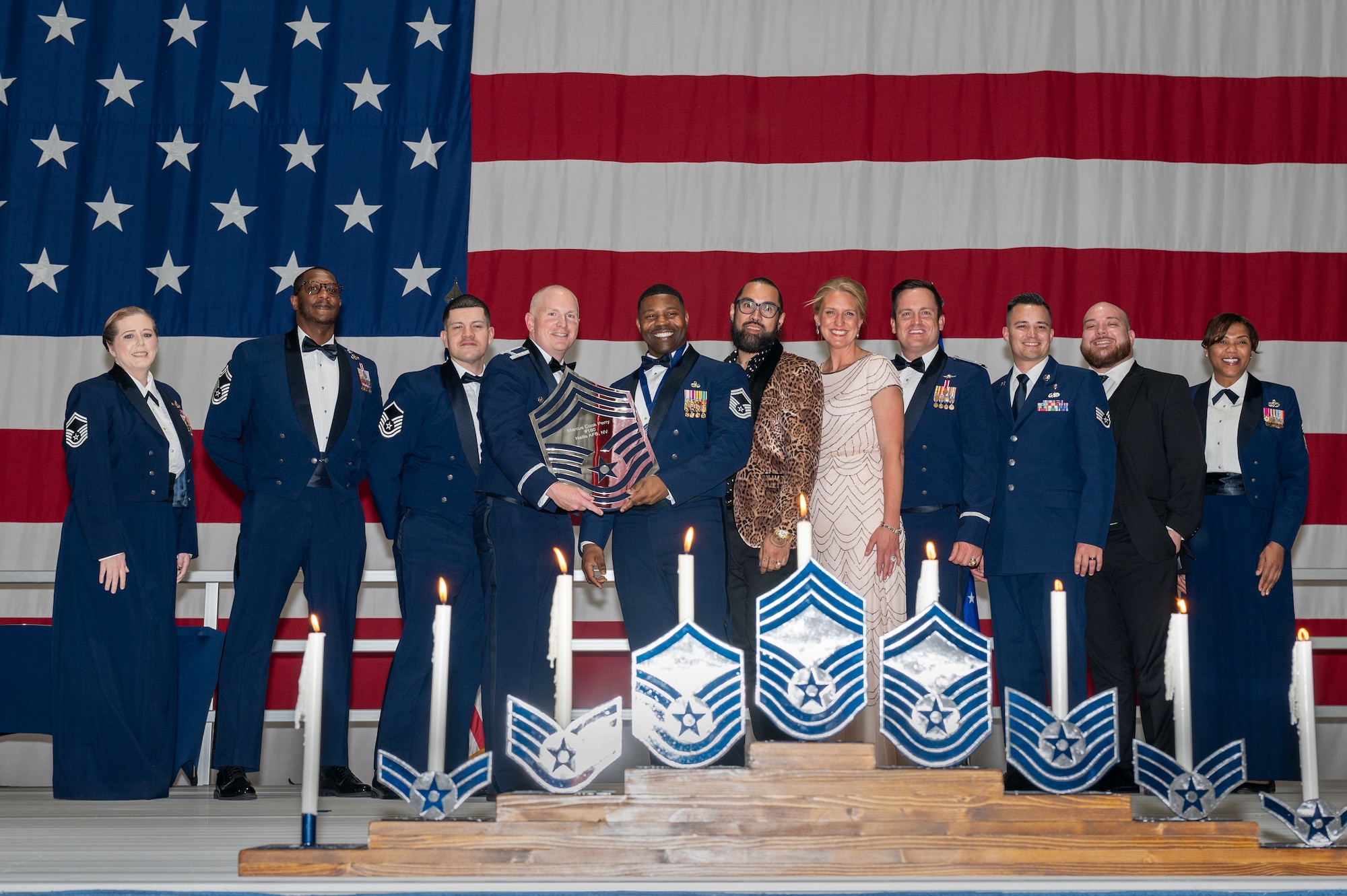 U.S. Air Force Senior Master Sgt. Marcus Cook Perry, the 99th Communications Squadron senior enlisted leader, receives a recognition plaque during the chief master sergeant recognition ceremony at Nellis Air Force Base, Nevada, April 20, 2024.