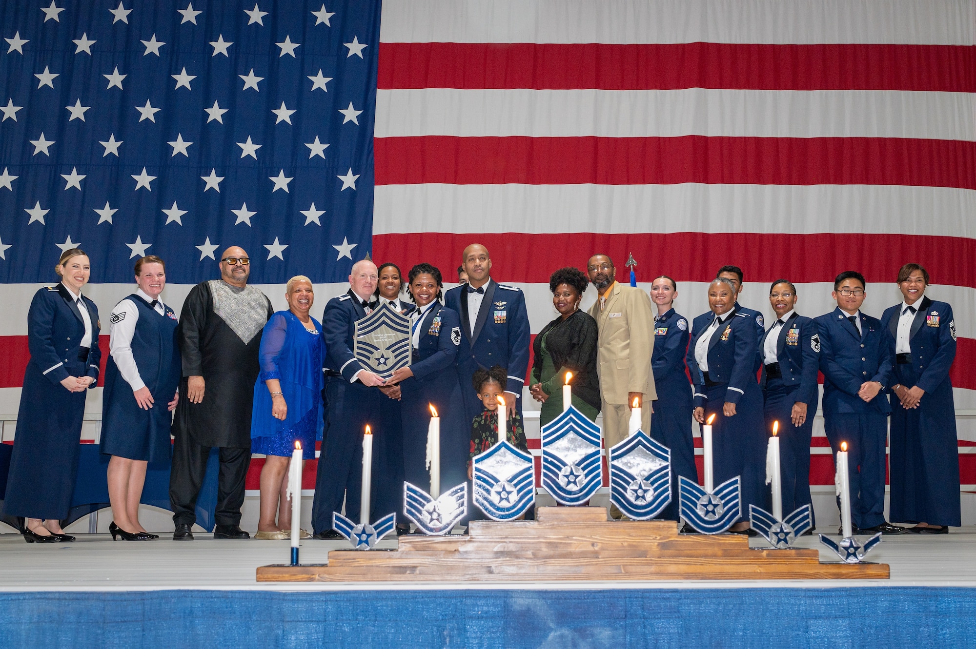 U.S. Air Force Senior Master Sgt. Chrishana Dameron, the 99th Inpatient Operations Squadron superintendent, receives a recognition plaque during the chief master sergeant recognition ceremony at Nellis Air Force Base, Nevada, April 20, 2024.