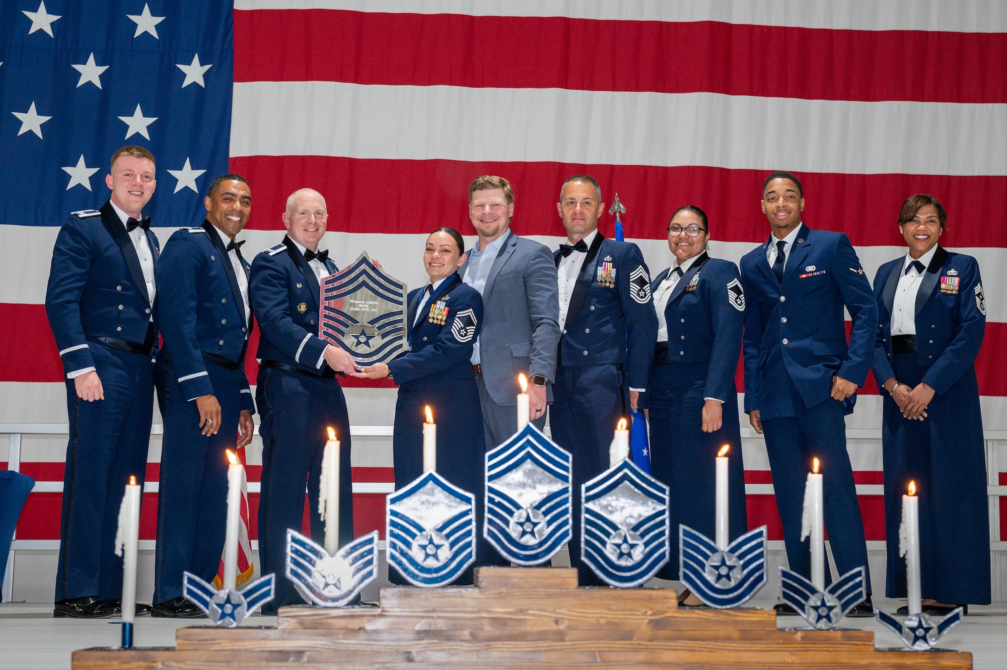 U.S. Air Force Senior Master Sgt. Shawna Latinis, the 99th Logistics Readiness Squadron materiel management flight chief, receives a recognition plaque during the chief master sergeant recognition ceremony at Nellis Air Force Base, Nevada, April 20, 2024.