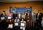 A group photo of individuals holding plaques.