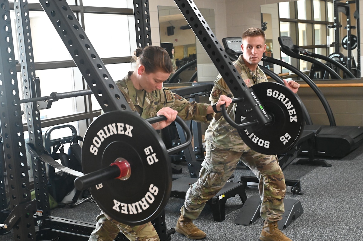 Staff Sgt. Taylor E. Linkous, S5/ Plans and Programs Officer assigned to the 42nd Security Forces Squadron trains with Capt. Ben T. Schmitt, Operational Support Team Physical Therapist, using OST equipment at the new centralized training center during a physical fitness session at Maxwell Air Force Base, Ala. April 22, 2024. This new area is open to all active-duty members from the designated unit who is assigned to the OST and who wants to improve their strength and conditioning, mental health, diet or overall physical well-being. (U.S. Air Force photo by Staff Sgt. Crystal A. Jenkins)
