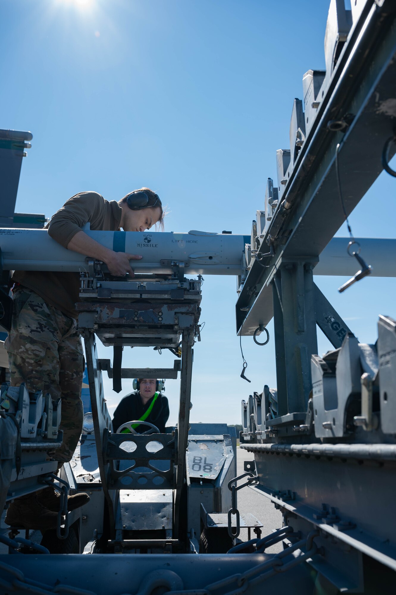 U.S. Air Force Airmen assigned to the 335th Fighter Generation Squadron load crew team, stabilize a weapon onto a bomb cart during a quarterly load crew competition at Seymour Johnson Air Force Base, North Carolina, April 5, 2024. Load crew competitions are a friendly competition between the 4th Fighter Wing’s fighter generation squadrons. (U.S. Air Force photo by Airman 1st Class Rebecca Sirimarco-Lang)