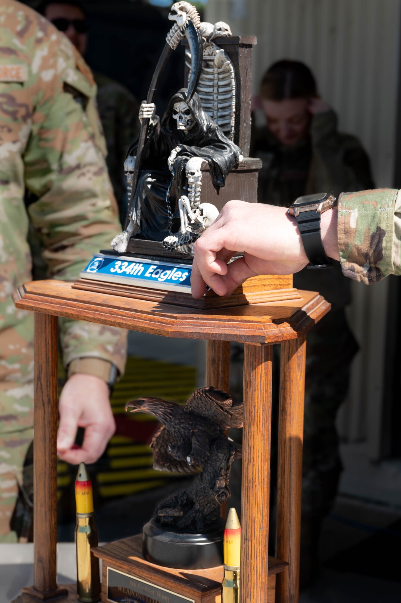334th Fighter Squadron plaque being placed on the trophy during a quarterly load crew competition at Seymour Johnson Air Force Base, North Carolina, April 5, 2024. Load crew competitions are a friendly competition between the 4th Fighter Wing’s fighter generation squadrons. (U.S. Air Force photo by Airman 1st Class Rebecca Sirimarco-Lang)