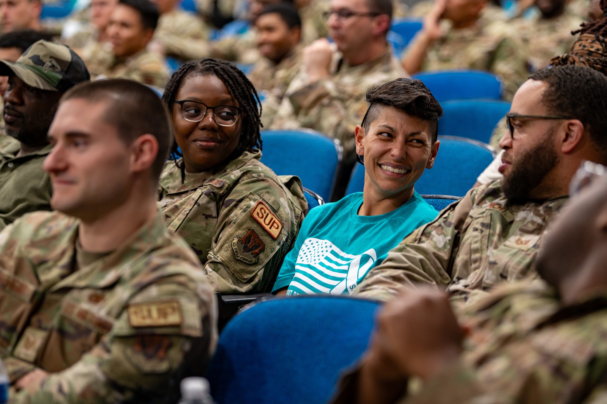 Airmen sit in a brief for sapr training
