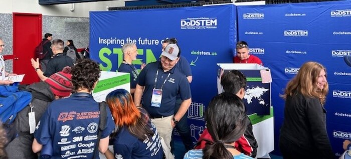 Air Force Sustainment Center’s STEM Outreach Program Managers manage their booth during the annual For Inspiration and Recognition of Science and Technology, or FIRST, Championship.