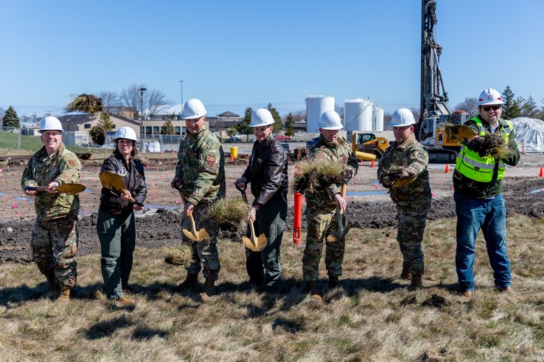 Current commander of the Air National Guard’s 128th Air Refueling Wing (ARW), Col. Charles Merkel (middle), is joined by previous 128th ARW commanders — Col. Adria Zucarro, Col. Michael Guch, and Col. Ted Metzger; Brig. Gen. David May, Assistant Adjutant General - Air, Wisconsin National Guard, Command Sgt. Maj. Chad Workman, Sean Giese, resident engineer, U.S. Army Corp of Engineers, Omaha District Fort McCoy Office to break ground during a ceremony at General Mitchell Air National Guard Base, Milwaukee, Wisconsin. This ceremony celebrates the construction commencement of a state-of-the-art Type III Petroleum, Oils and Lubricants facility.
