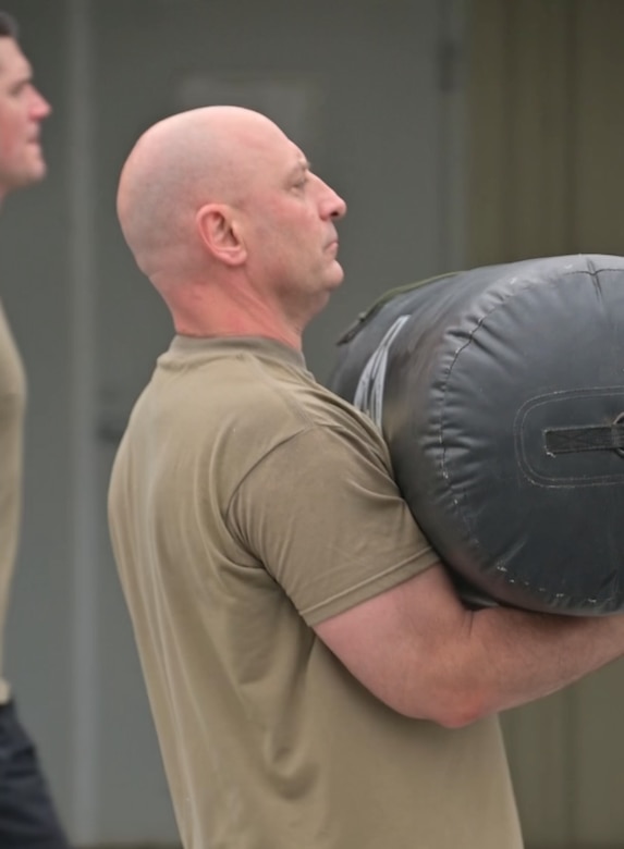 Command Sgt. Maj. Shawn Phillips, Pennsylvania National Guard command senior enlisted leader, works out with Airmen from the 193rd Special Operations Wing's 148th Air Support Operations Squadron during the filming of one of his "Fitness with Phillips" videos. (Pennsylvania National Guard photo by 2nd Lt. Kate Kramer)