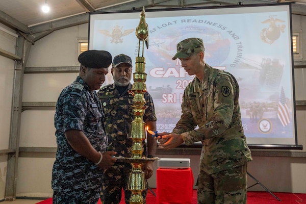 Lt. Col. Anthony Nelson, U.S. Defense Attaché to Sri Lanka, lights a ceremonial oil lamp to mark the beginning of exercise Cooperation Afloat Readiness and Training (CARAT) Sri Lanka 2024 alongside members of the Sri Lanka Navy (SLN) at SLNS Vidura, April 22. CARAT Sri Lanka is a bilateral exercise between Sri Lanka and the United States designed to promote regional security cooperation and strengthen maritime understanding, partnerships, and interoperability. In its 29th year, the CARAT series is comprised of multinational exercises, designed to enhance U.S. and partner forces’ abilities to operate together in response to traditional and non-traditional maritime security challenges in the Indo-Pacific region. (U.S. Navy photo by Mass Communication Specialist 1st Class Charles Oki)