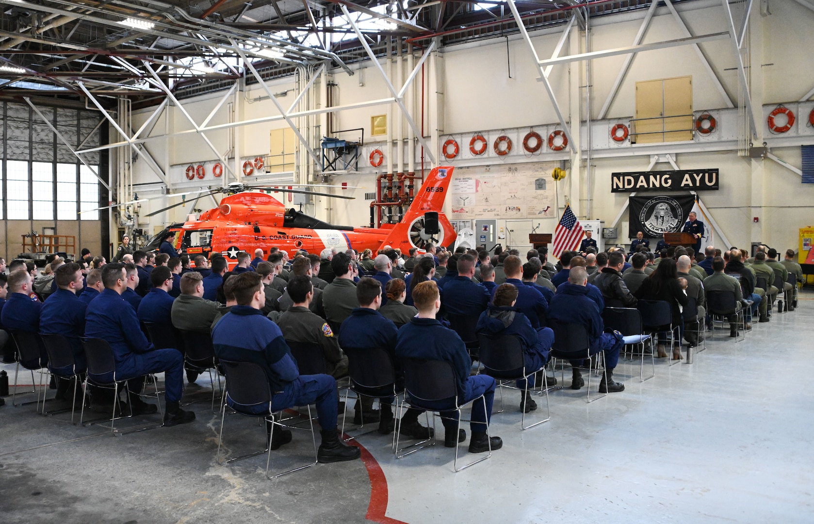 Members of Air Station Kodiak attend a ceremony to retire the MH-65 Dolphin helicopter airframe at Air Station Kodiak, April 23, 2024. Air Station Kodiak will be the fourth Coast Guard Air Station to transition to a single rotary-wing ship and shore-based fleet of nine MH-60 Jayhawks in 2025. (U.S. Coast Guard photo by Petty Officer Second Class Ian Gray)