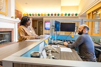Motisola McKinnon, workforce development branch head, Code 1182, Command University, talks with Brad Taylor, critical coatings inspector, Code 133.1, Non- Nuclear Inspection Division, Shipboard, April 17, 2024, inside Olympic Lodge on Naval Base Kitsap-Bremerton, Washington. (U.S. Navy photo by Jeb Fach)