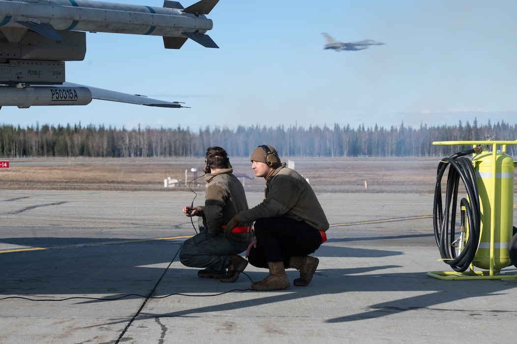 A pre-flight inspection is completed by two Airmen.