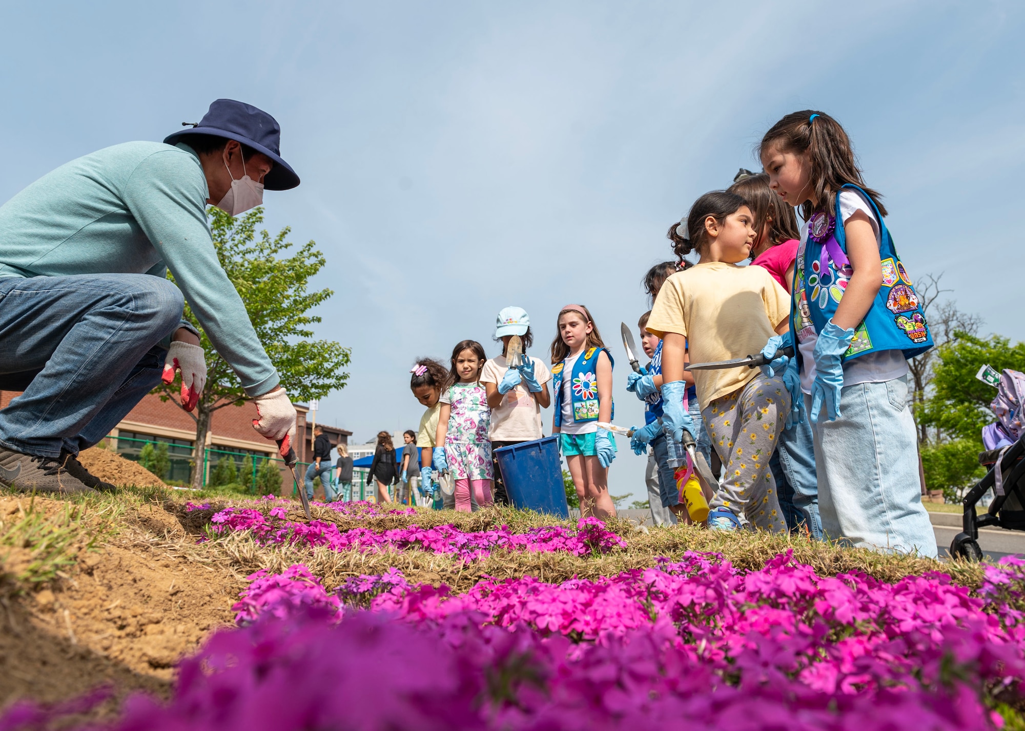 Members of Osan Girl Scouts prepare to plant vegetation during an Earth Day planting event April 19, 2024 at Osan Air Base, Republic of Korea. The scouts helped the Osan Elementary School staff plant trees, bushes and flowers in celebration of Earth Day. Although Earth Day falls within the month of April, the Department of Defense observes Earth Day every day because the health of the planet is critical to projecting combat power and sustaining military readiness. (U.S. Air Force photo by Staff Sgt. Aubree Owens)