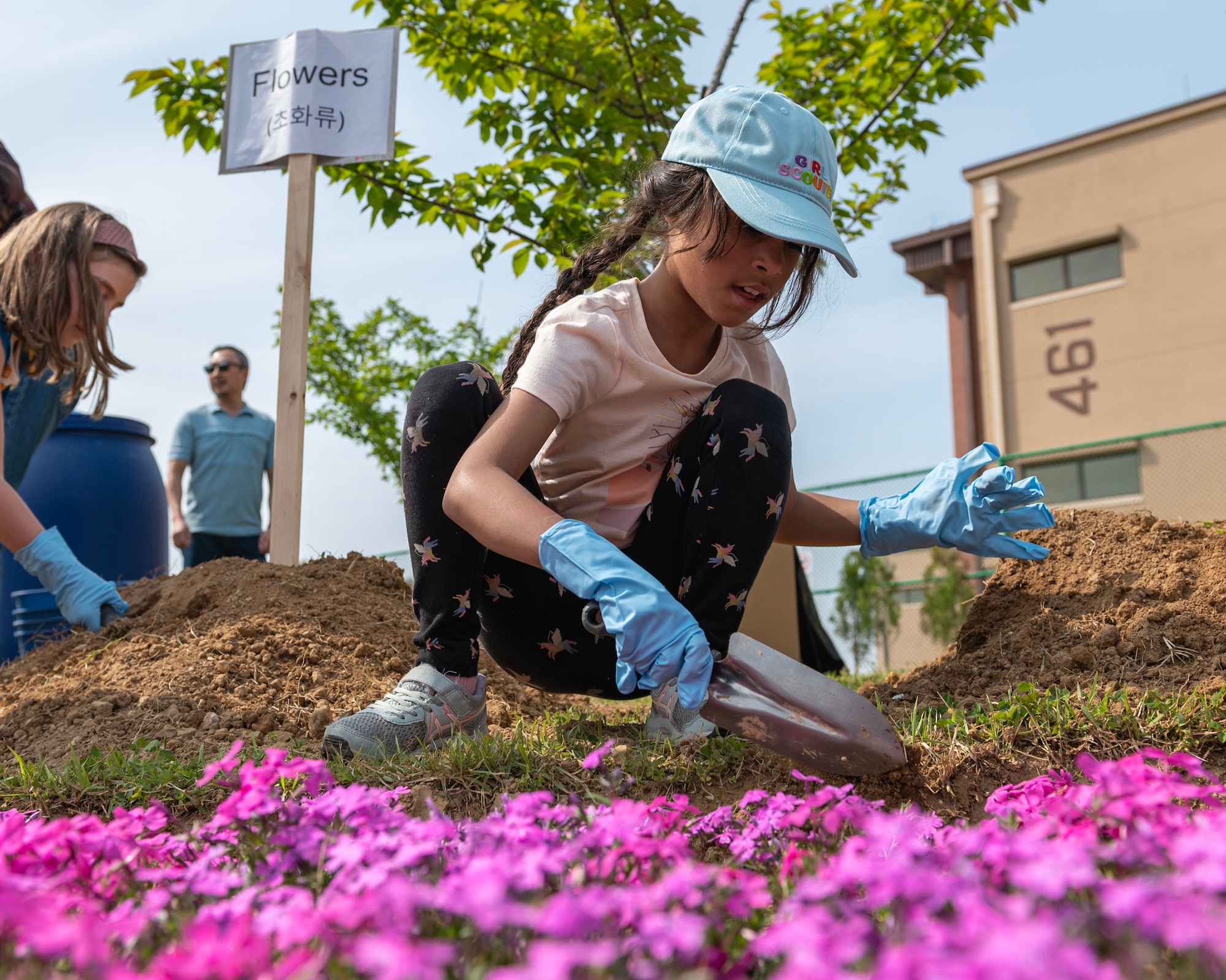 A member of Osan Girl Scouts uses a shovel to plant a flower during an Earth Day planting event April 19, 2024 at Osan Air Base, Republic of Korea. The Scouts learned about Earth Day and helped plant trees, bushes and flowers. Although Earth Day falls within the month of April, the Department of Defense observes Earth Day every day because the health of the planet is critical to projecting combat power and sustaining military readiness. (U.S. Air Force photo by Staff Sgt. Aubree Owens)
