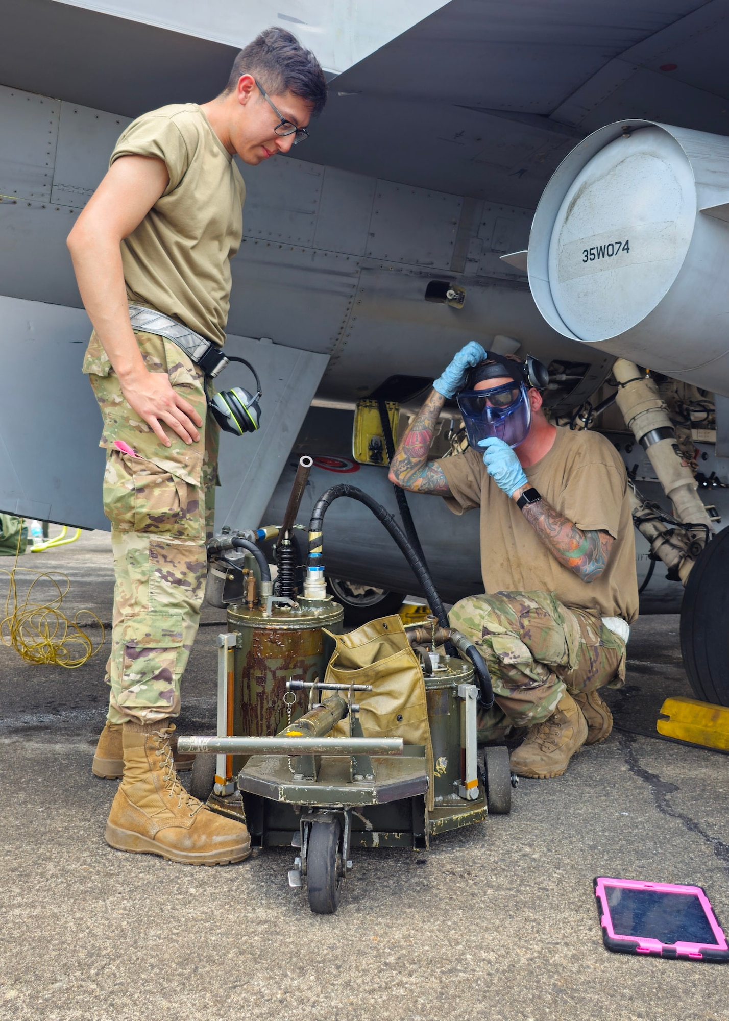 U.S. Air Force Airman 1st Class Jeley Garcia and Tech. Sgt. Mitchell Westpfahl,13th Fighter Squadron aircraft structural maintenance specialists, perform oil servicing for a F-16 during Cope Thunder Philippines 24-1 at Basa Air Base, Pampanga, Philippines, April 12, 2024. CT PH 24-1 builds on the foundation set to maintain peace and stability through the U.S.-Philippine Alliance. (U.S. Air Force photo by Tech. Sgt. Connor Macklin)