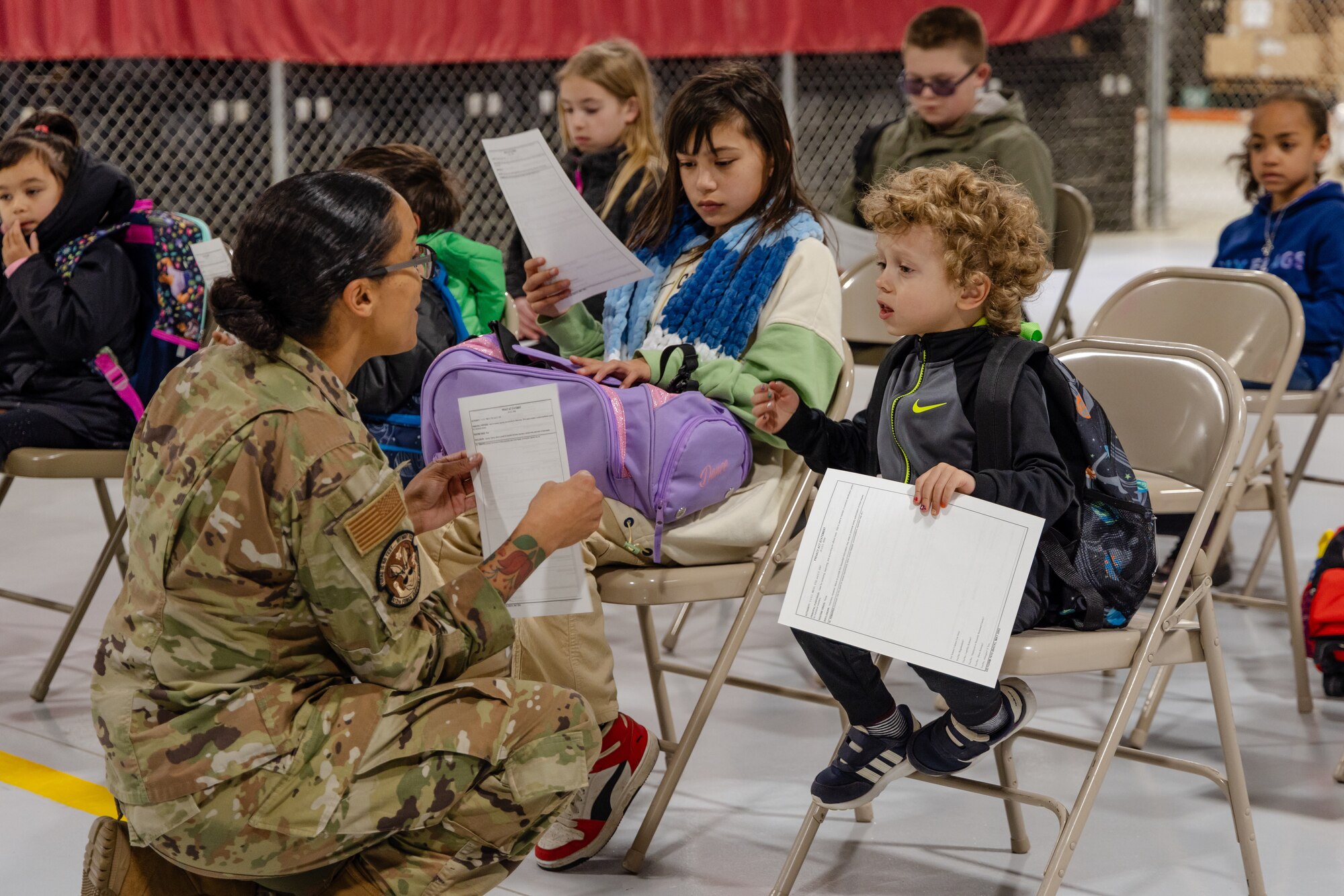 Senior Master Sgt. Tanya Sipos, 412th Force Support Squadron Senior Enlisted Leader, welcomes children to Operation Kids Understand Deployment Operations or KUDOS at Edwards Air Force Base, California, March 1. (Air Force photo by Lindsey Iniguez)