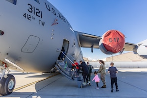 Edwards children receive a brief on C-17 Globemaster III operations from Tech. Sgt. Samantha Martino, 418th Flight Test Squadron, while onboard the aircraft during Operation Kids Understand Deployment Operations or KUDOS at Edwards Air Force Base, California, March 1. (Air Force photo by Lindsey Iniguez)