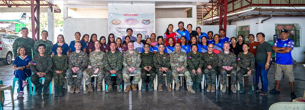 240421-M-FP389-2384 PHILIPPINES (April 23, 2024) Philippine and U.S. service members with the Combined Joint Civil-Military Operations Task Force pose for a photograph with local healthcare workers and Ilocos Norte residents after a community health engagement held before Exercise Balikatan 24 at Davila Elementary School in Pasuquin, Ilocos Norte, Philippines, April 21, 2024. The Philippine and U.S. service members trained Ilocos Norte healthcare workers and residents on basic lifesaving skills such as cardiopulmonary resuscitation and tactical combat casualty care, increasing emergency care access and awareness. BK 24 is an annual exercise between the Armed Forces of the Philippines and the U.S. military designed to strengthen bilateral interoperability, capabilities, trust, and cooperation built over decades of shared experiences. (U.S. Marine Corps photo by Cpl. Trent A. Henry)