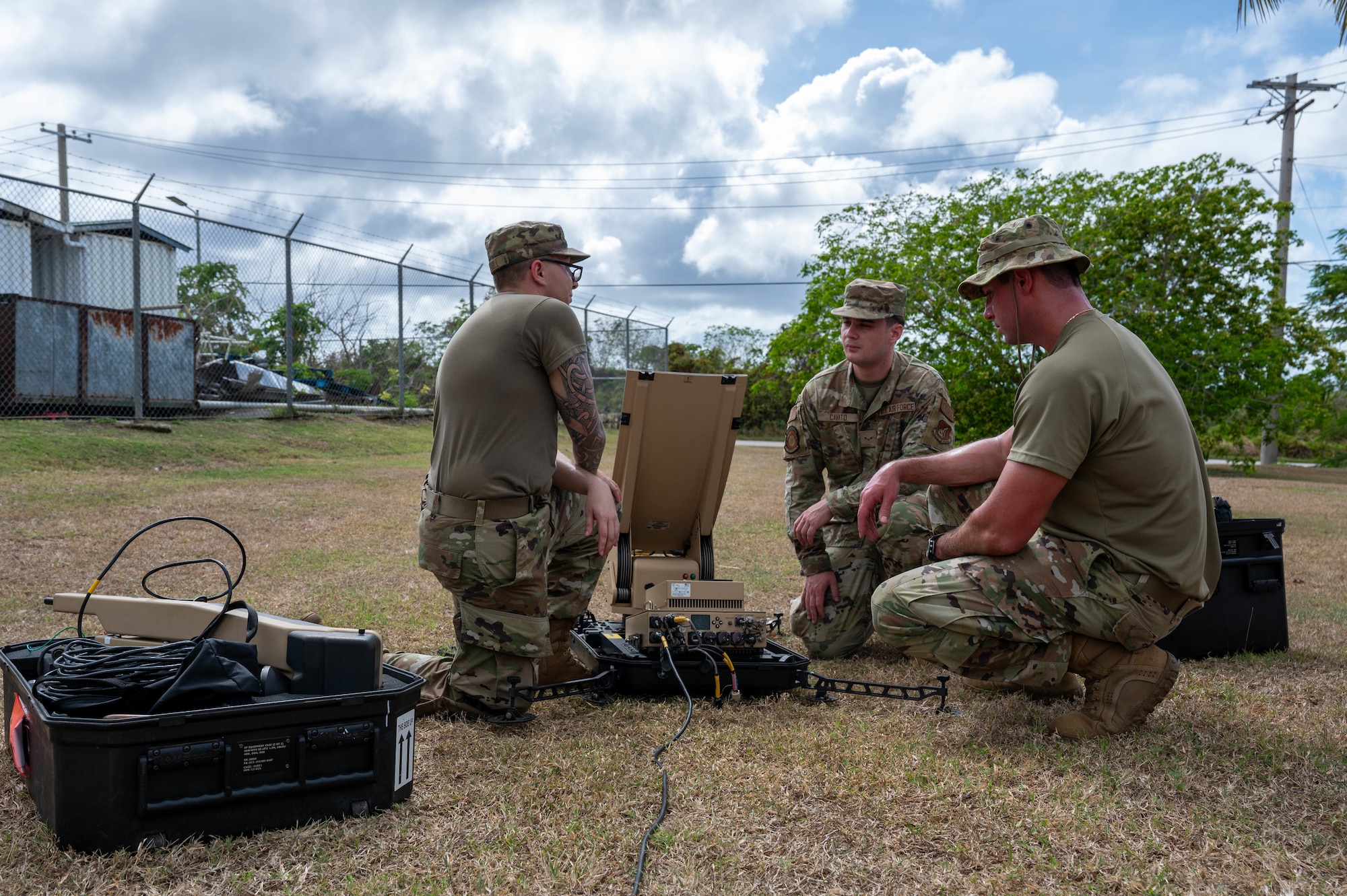 Airmen raise a small standard shelter during an exercise.