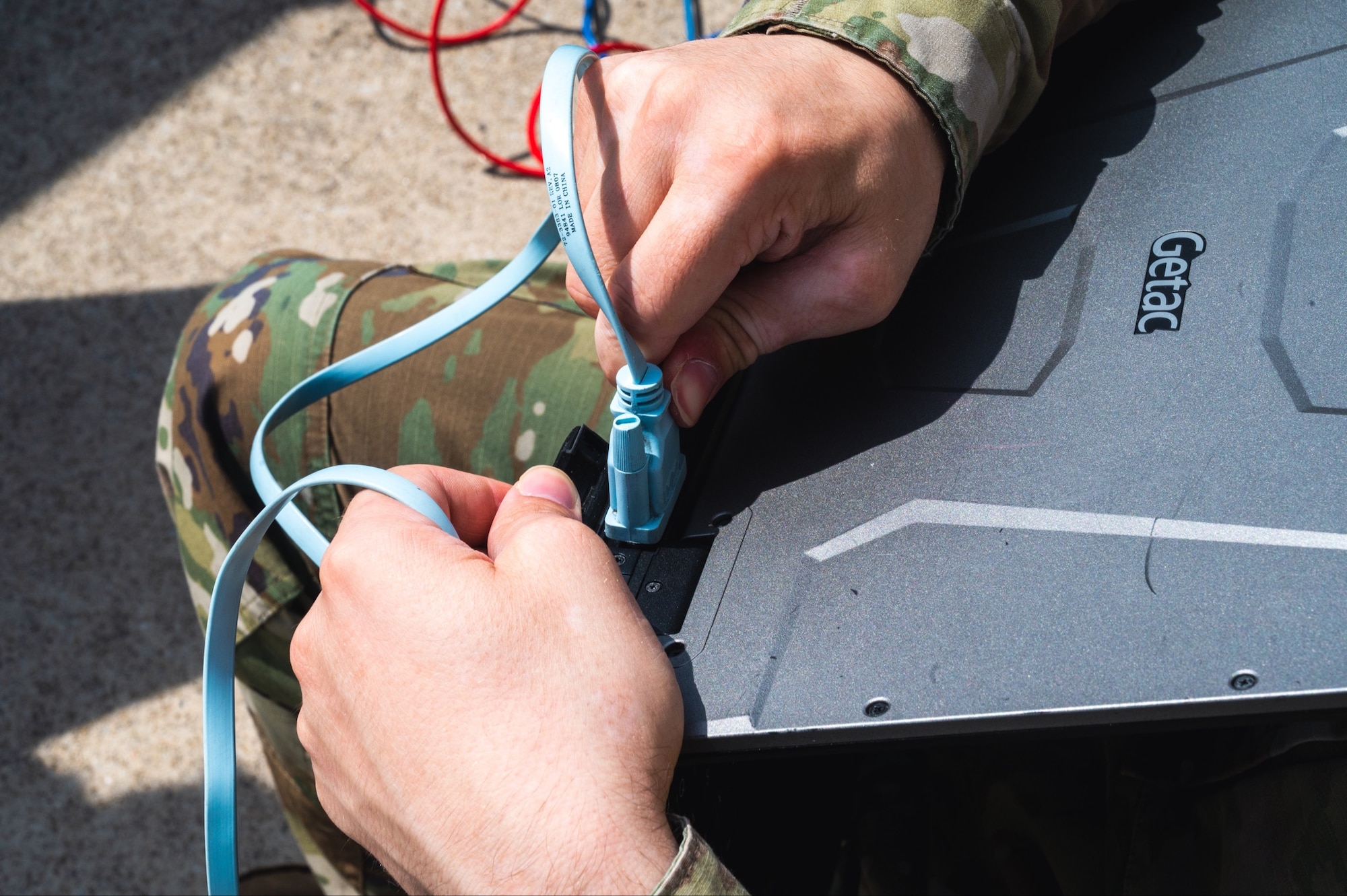 Staff Sgt. Nathaniel Garcia configures a computer to establish a command and control (C2) station.
