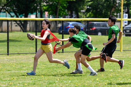 Yokota Middle School and Fussa Dai-ichi Junior High School students participate in a flag football match.