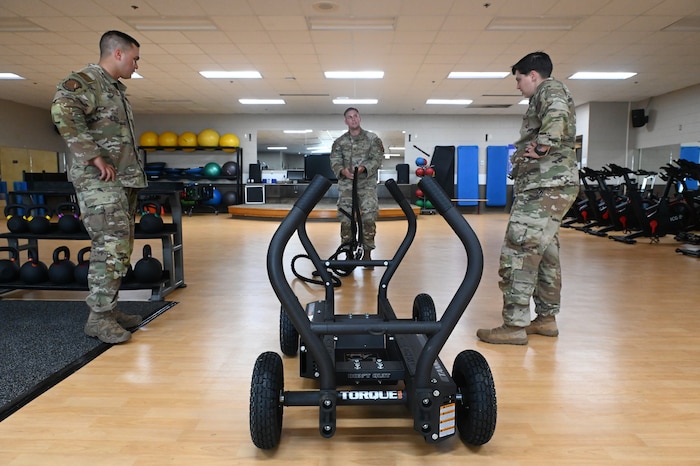 Capt. Ben T. Schmitt, Operational Support Team Physical Therapist, demonstrates the use of the OST equipment at the new centralized training center during a physical fitness session with 42nd Security Forces Squadron Airmen at Maxwell Air Force Base, Ala. April 22, 2024. This new area is open to all active-duty members from the designated unit who is assigned to the OST and who wants to improve their strength and conditioning, mental health, diet or overall physical well-being. (U.S. Air Force photo by Staff Sgt. Crystal A. Jenkins)