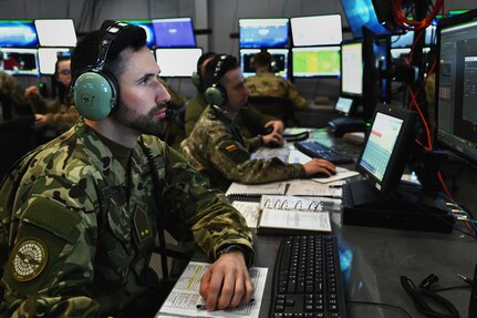 Hungarian Defence Forces 1st Lt. Mate Nagy, a fighter controller assigned to the Common Reporting Center,  trains on large force employment tactics during a joint training exercise March 22, 2024 in Blue Ash, Ohio. Success in contested environments depends on how well U.S. forces combine with the broad range of allied and partner capabilities and expertise to secure our common interests and promote our shared values. (U.S. Air National Guard photo by Shane Hughes)