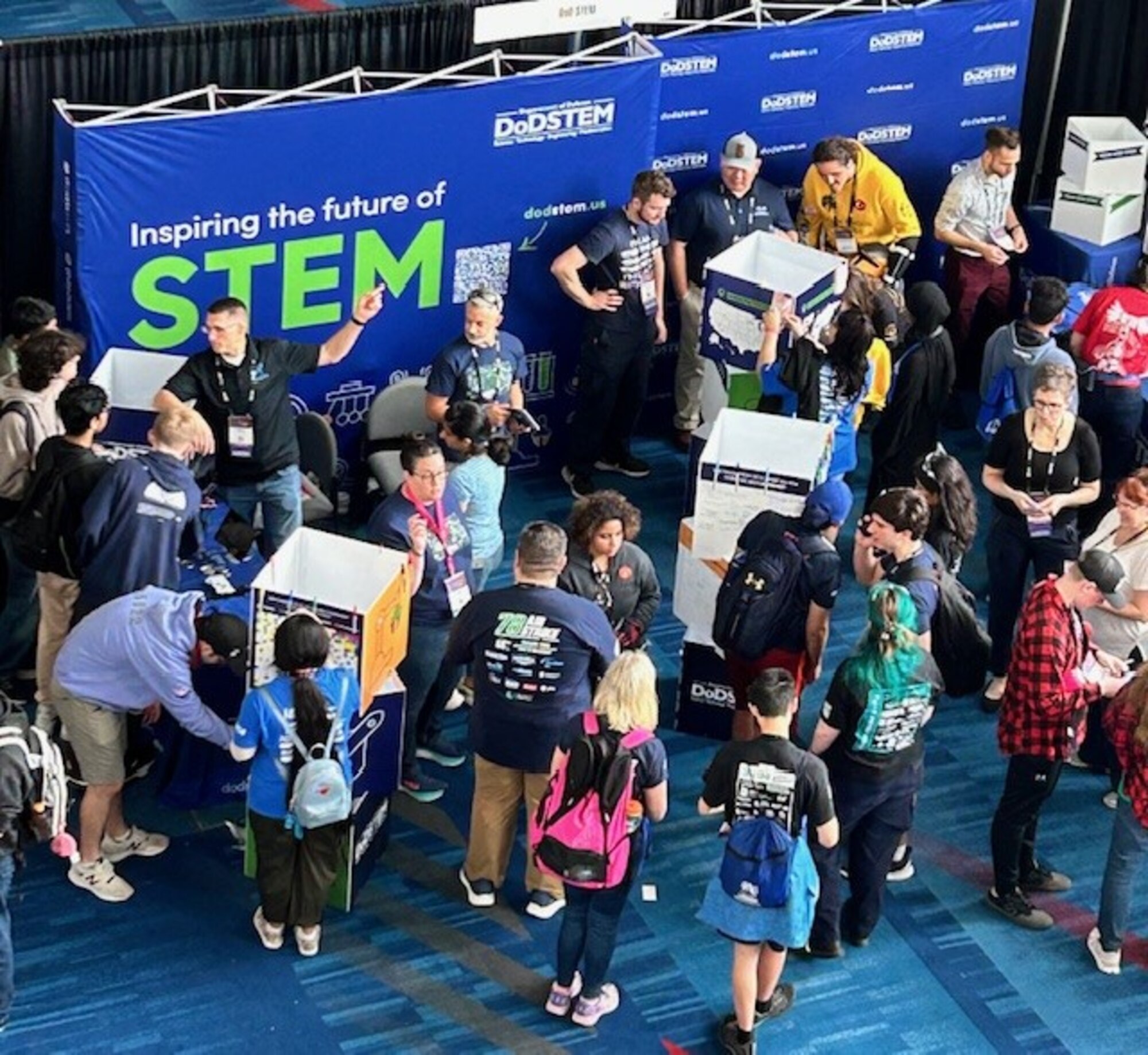 Air Force Sustainment Center’s STEM Outreach Program Managers manage their booth during the annual For Inspiration and Recognition of Science and Technology, or FIRST, Championship.