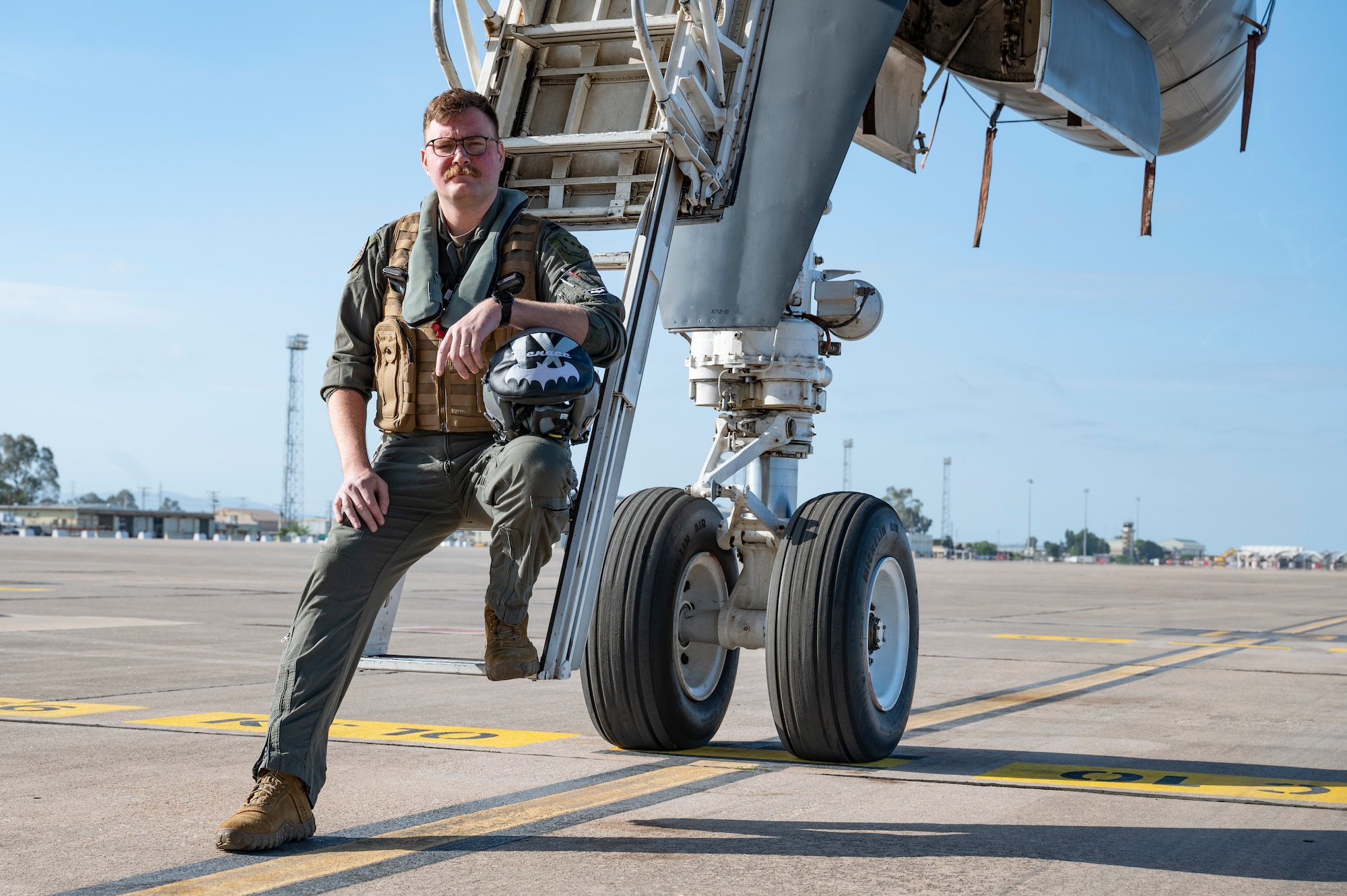 U.S. Air Force Capt. Joshua Cover, 9th Expeditionary Bomb Squadron weapons system officer, poses for a photo on the ladder of a B-1B Lancer assigned to Dyess Air Force Base, Texas, at Morón Air Base, Spain, during Bomber Task Force Europe April 22, 2024. Cover began his career at Dyess as an enlisted electronic warfare specialist, later commissioning to become a WSO. He is currently on the BTF using his knowledge to contribute to the 9th EBS’s global deterrence mission. (U.S. Air Force photo by Airman 1st Class Emma Anderson