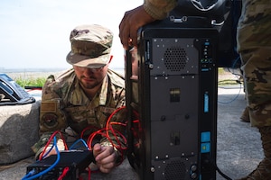 Staff Sgt. Nathaniel Garcia configures communications for a command and control (C2) station.