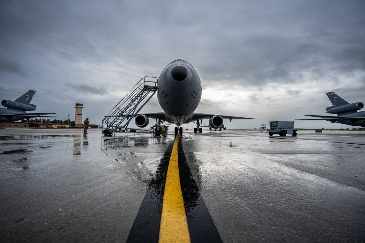 Front view of a KC-10 sitting on a wet runway